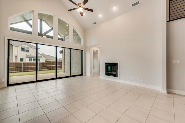 2802 Chandler Ct, Mansfield, TX 76063 - unfurnished living room with ceiling fan, high vaulted ceiling, a glass covered fireplace, baseboards, and tile patterned floors