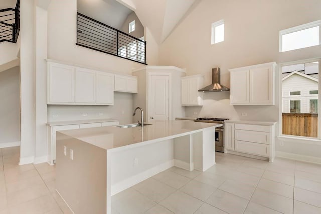 2802 Chandler Ct, Mansfield, TX 76063 - kitchen with a sink, high end stainless steel range oven, a towering ceiling, wall chimney range hood, and an island with sink