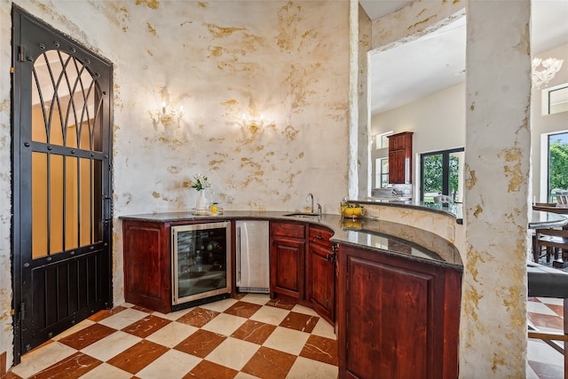 bar featuring stainless steel fridge, wine cooler, and sink