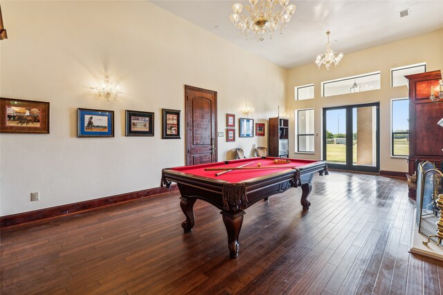 game room featuring a high ceiling, a notable chandelier, billiards, and dark hardwood / wood-style flooring