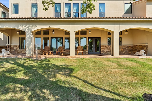 back of house with a patio, french doors, and a yard