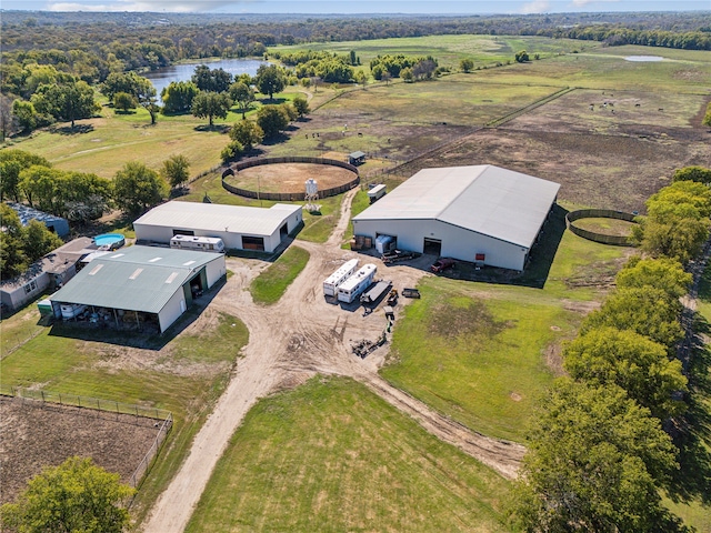 birds eye view of property featuring a water view and a rural view