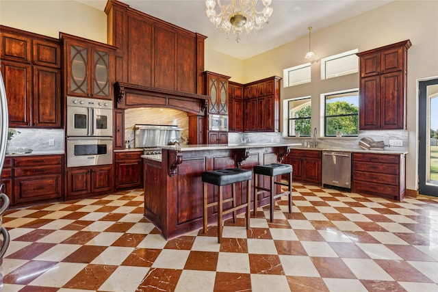 kitchen featuring backsplash, stainless steel appliances, a center island, and pendant lighting