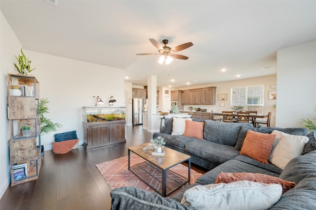 living room with dark wood-type flooring and ceiling fan