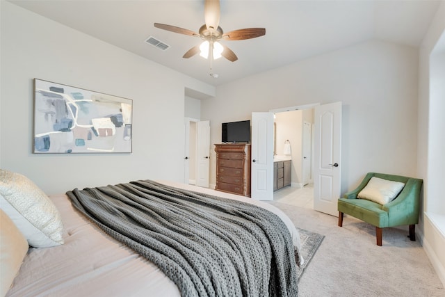 carpeted bedroom with lofted ceiling, ensuite bath, and ceiling fan