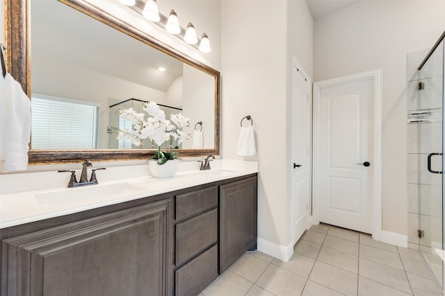 bathroom with a shower with door, tile patterned flooring, and vanity