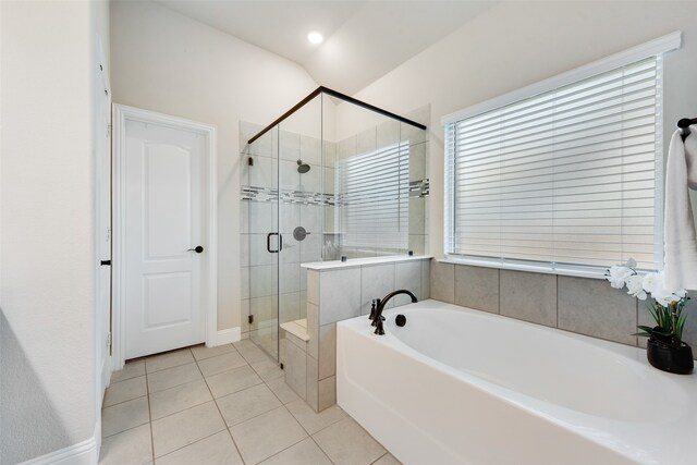 bathroom featuring plus walk in shower and tile patterned flooring