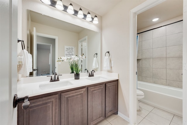 full bathroom with vanity, tiled shower / bath combo, toilet, and tile patterned floors