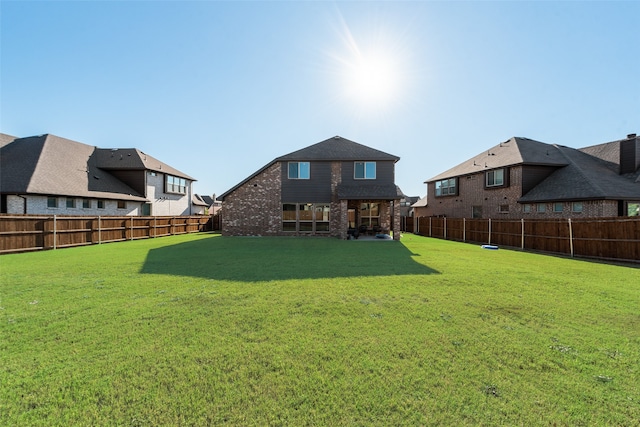 rear view of house featuring a lawn