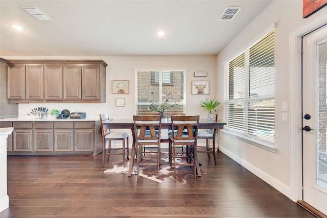 dining space with dark hardwood / wood-style flooring