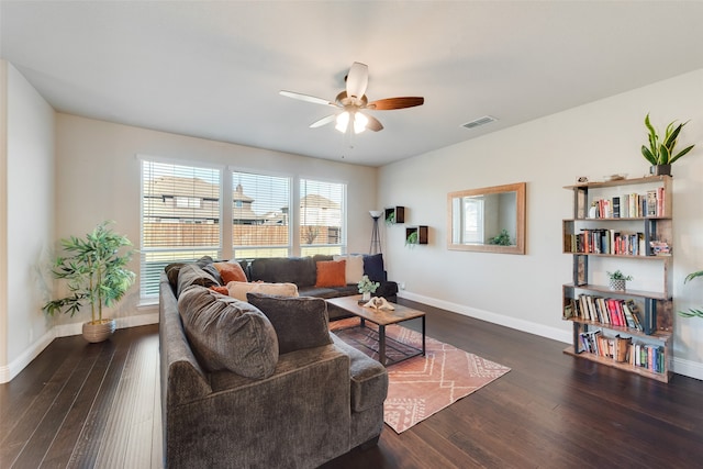 living room featuring ceiling fan and dark hardwood / wood-style flooring