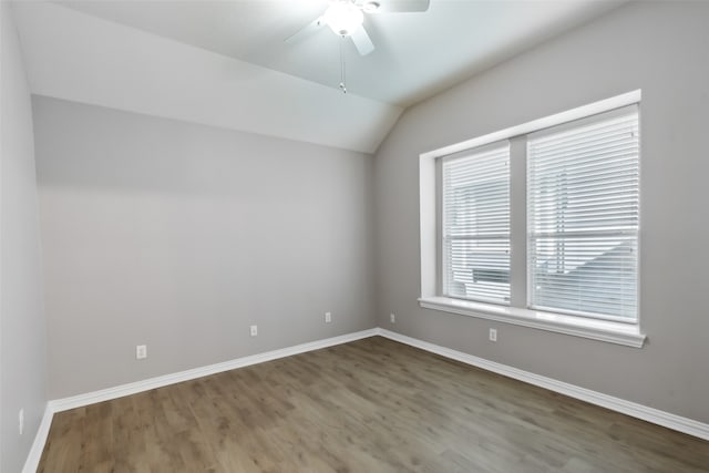 unfurnished room with lofted ceiling, wood-type flooring, and ceiling fan