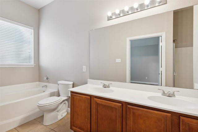 bathroom featuring toilet, a tub to relax in, vanity, and tile patterned flooring