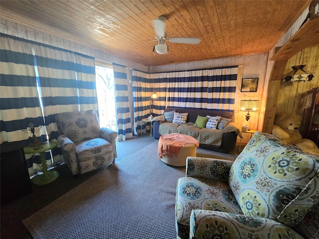 carpeted living room with wooden walls, ceiling fan, and wooden ceiling