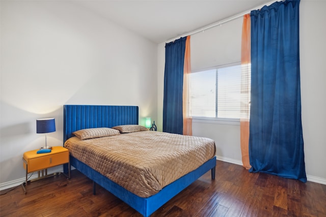 bedroom with dark hardwood / wood-style flooring