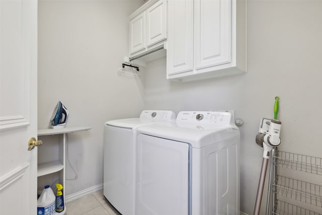 laundry room with independent washer and dryer, cabinets, and light tile patterned floors