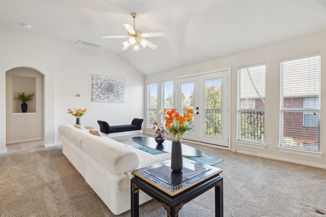 carpeted living room with french doors, vaulted ceiling, ceiling fan, and plenty of natural light