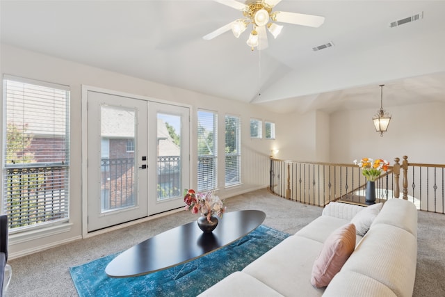 living room featuring lofted ceiling, french doors, light carpet, and ceiling fan