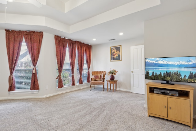 sitting room with light carpet, a healthy amount of sunlight, and ceiling fan