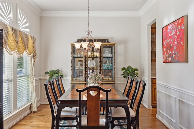 dining room featuring ornamental molding, a chandelier, and hardwood / wood-style floors