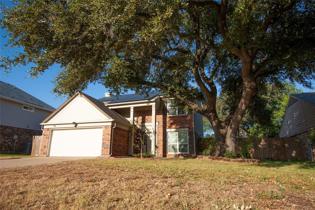 view of front of property with a front yard and a garage