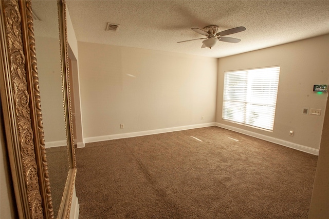 carpeted empty room with a textured ceiling and ceiling fan