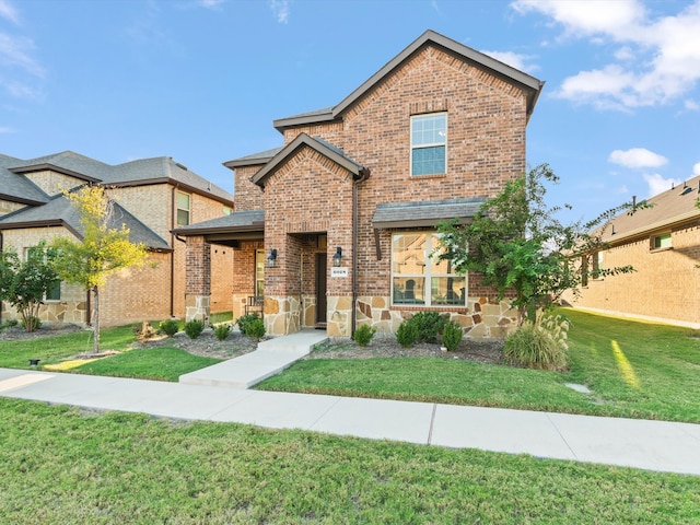 view of front of house with a front yard and a patio area