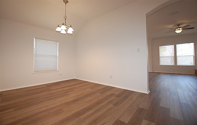 spare room featuring ceiling fan with notable chandelier, lofted ceiling, and dark hardwood / wood-style floors