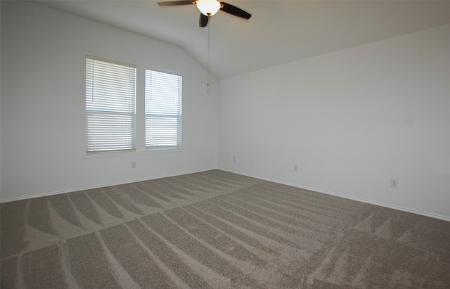 carpeted empty room with lofted ceiling and ceiling fan