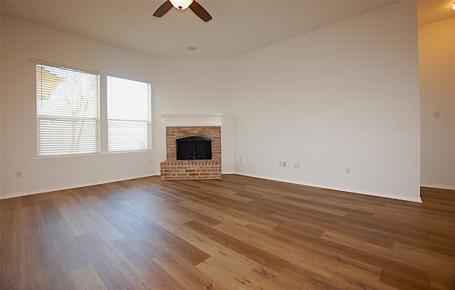 unfurnished living room featuring ceiling fan, a fireplace, and hardwood / wood-style floors