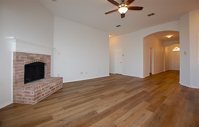 unfurnished living room featuring ceiling fan, a fireplace, and hardwood / wood-style floors