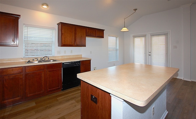 kitchen featuring lofted ceiling, black dishwasher, dark wood-type flooring, pendant lighting, and sink