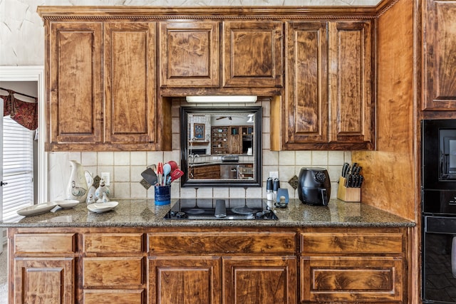 kitchen with backsplash and black appliances