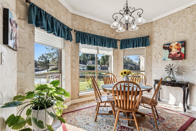 dining area with crown molding, a wealth of natural light, and a chandelier