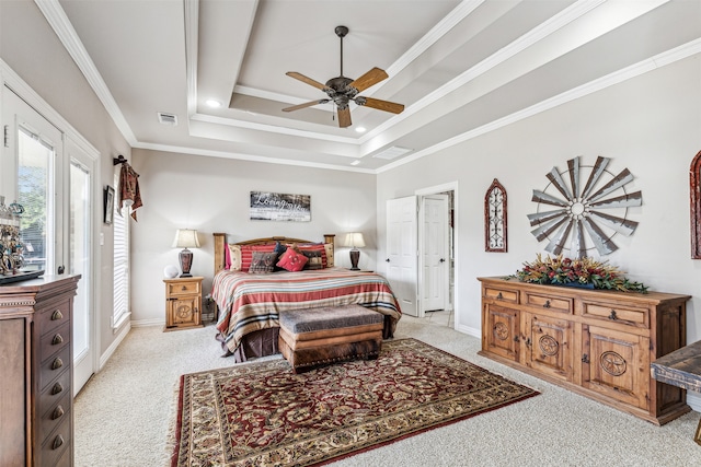 bedroom featuring ceiling fan, ornamental molding, a tray ceiling, and light colored carpet