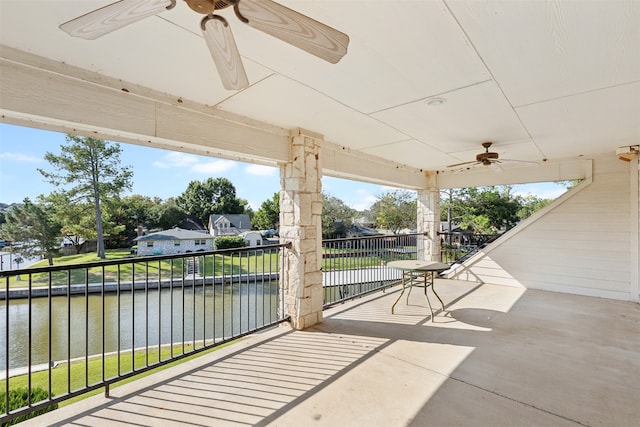 view of patio featuring a water view and ceiling fan