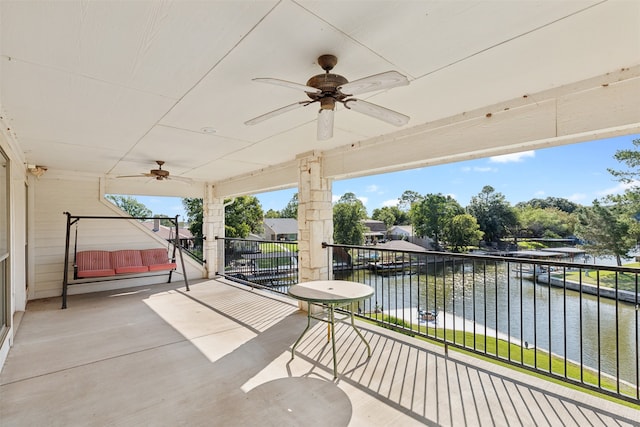 view of patio featuring a balcony, a water view, and ceiling fan