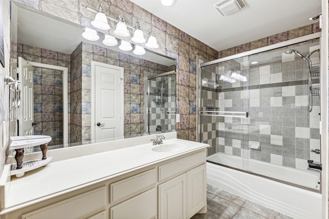 bathroom featuring vanity, combined bath / shower with glass door, tile walls, and tile patterned flooring