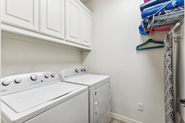 washroom featuring cabinets and washer and dryer