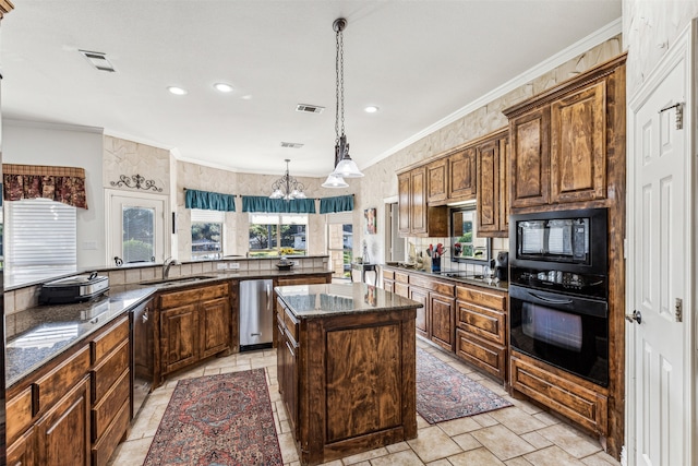 kitchen featuring a center island, a healthy amount of sunlight, black appliances, and kitchen peninsula