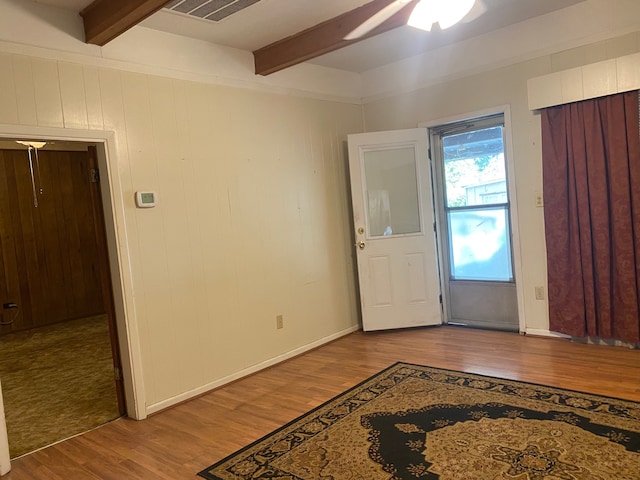 entryway with light hardwood / wood-style floors, beamed ceiling, and ceiling fan