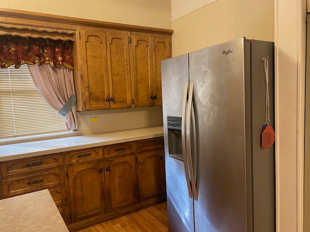 kitchen with stainless steel fridge and light hardwood / wood-style flooring