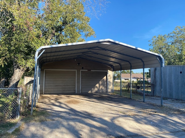 view of car parking featuring a carport and a garage