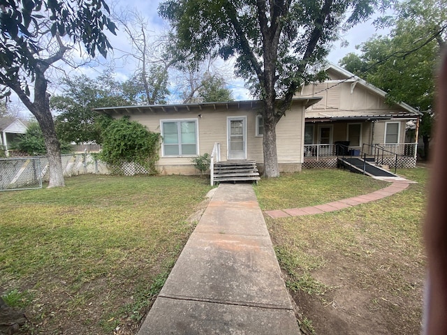 bungalow-style home with a front yard