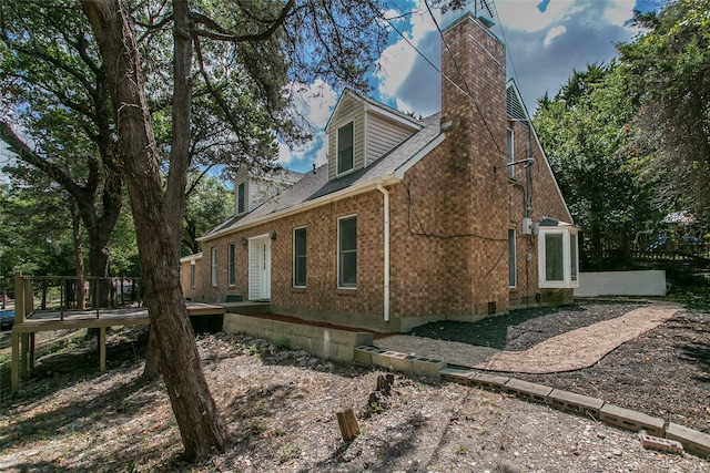 view of side of home with a wooden deck