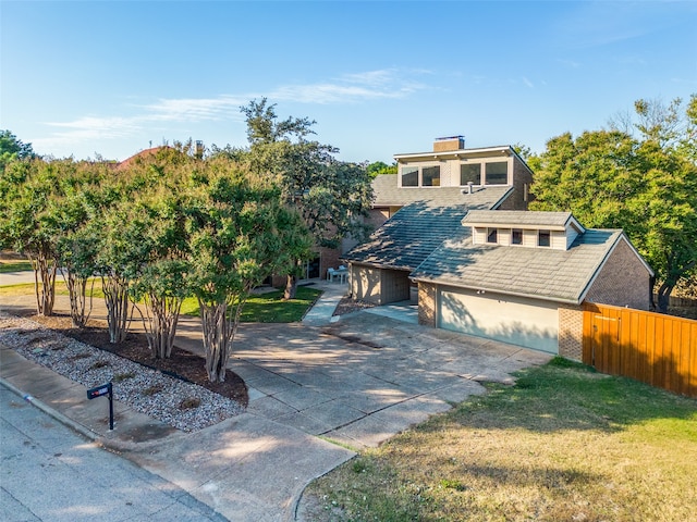 view of front of property with a front yard and a garage