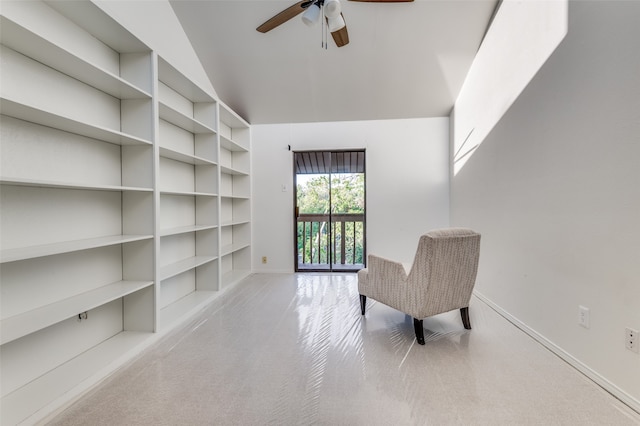 living area with light colored carpet, a high ceiling, and ceiling fan