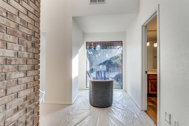 hallway with light hardwood / wood-style flooring and plenty of natural light