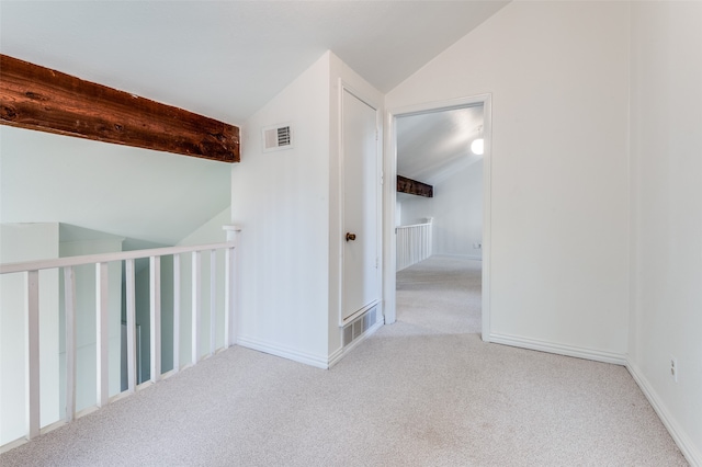 hall featuring light carpet and lofted ceiling