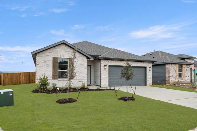 view of front facade with a front lawn and a garage